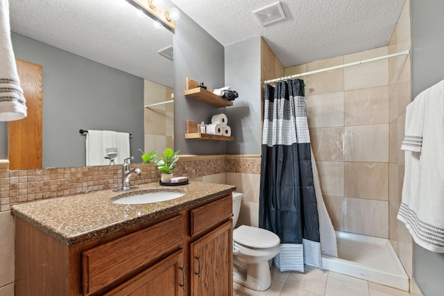 7734 Lancaster Ave NE, Otsego, MN 55301 - bathroom with tile walls, vanity, tile patterned floors, a tile shower, and a textured ceiling