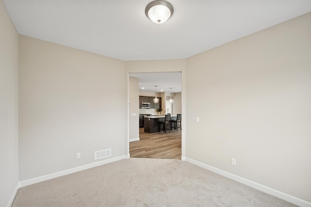 464 Whitewater Ct, Delano, MN 55328 - unfurnished room with baseboards and light carpet