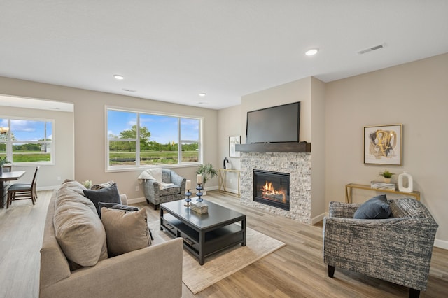 464 Whitewater Ct, Delano, MN 55328 - living room featuring baseboards, light wood-style floors, a fireplace, and recessed lighting