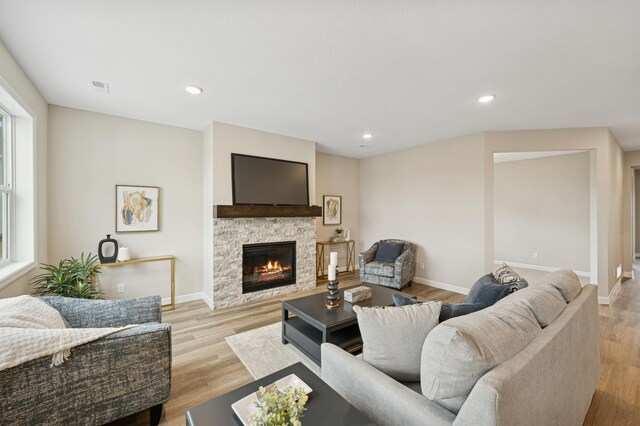 464 Whitewater Ct, Delano, MN 55328 - living room featuring a fireplace, baseboards, light wood finished floors, recessed lighting, and plenty of natural light