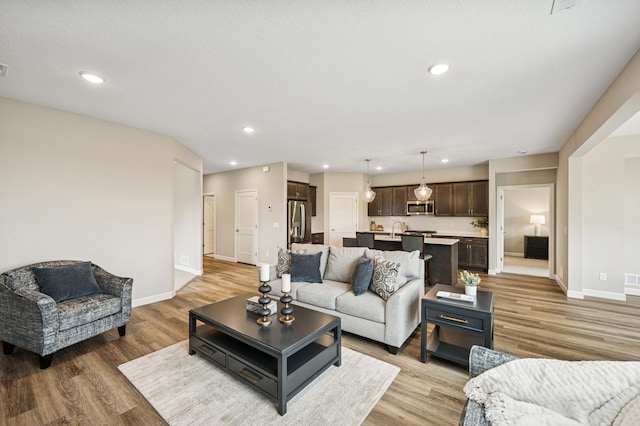 464 Whitewater Ct, Delano, MN 55328 - living room featuring light wood finished floors, baseboards, and recessed lighting