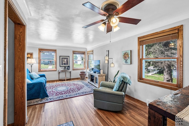 1551 Margaret St, Saint Paul, MN 55106 - living area with a ceiling fan, wood finished floors, and baseboards