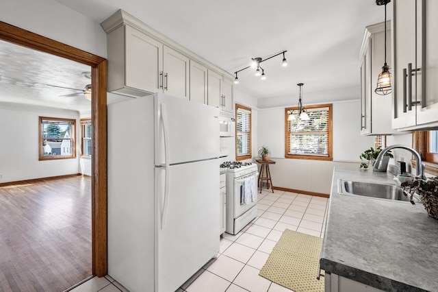 1551 Margaret St, Saint Paul, MN 55106 - kitchen with white appliances, a sink, plenty of natural light, and ceiling fan
