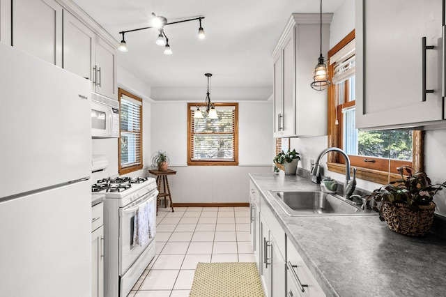 1551 Margaret St, Saint Paul, MN 55106 - kitchen featuring white appliances, a sink, decorative light fixtures, light tile patterned flooring, and a wainscoted wall