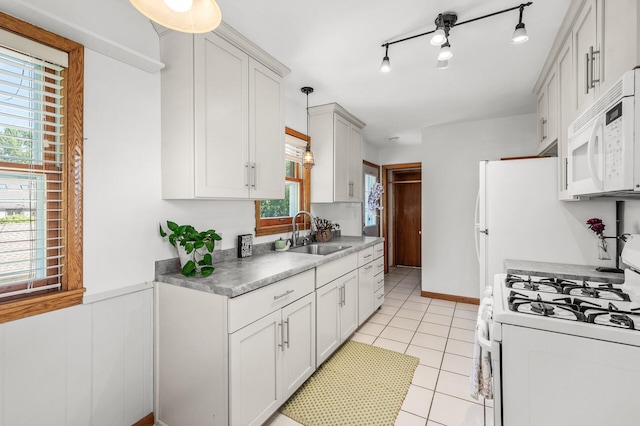 1551 Margaret St, Saint Paul, MN 55106 - kitchen featuring white appliances, a sink, light countertops, light tile patterned flooring, and pendant lighting