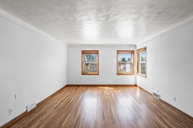 1551 Margaret St, Saint Paul, MN 55106 - empty room with wood finished floors and baseboards