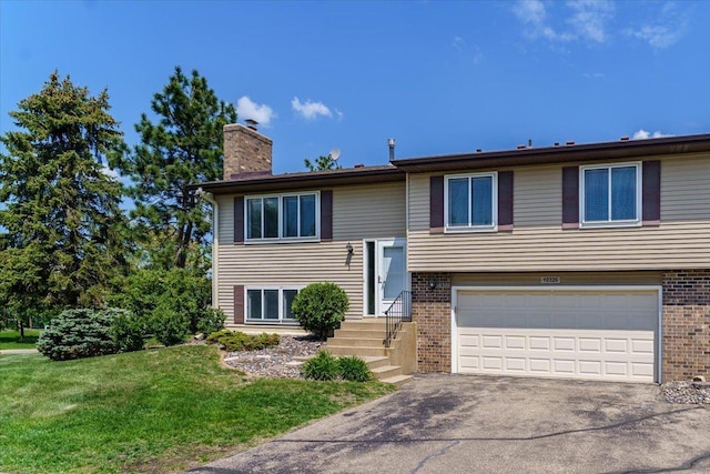 10326 Balsam Ln, Eden Prairie, MN 55347 - raised ranch featuring an attached garage, a chimney, brick siding, asphalt driveway, and a front lawn