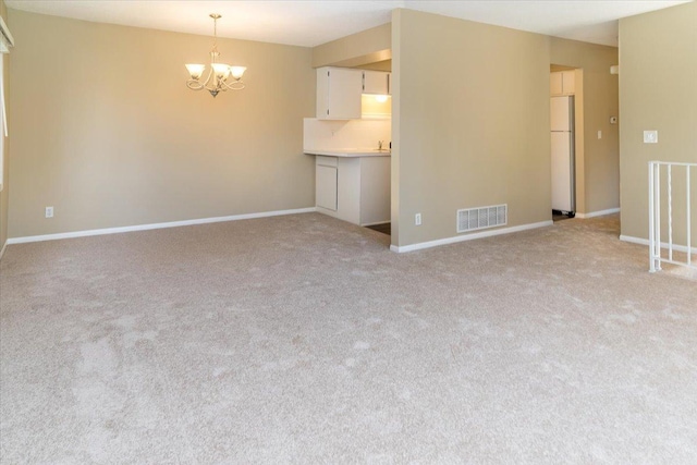 10326 Balsam Ln, Eden Prairie, MN 55347 - unfurnished living room featuring a chandelier and light carpet