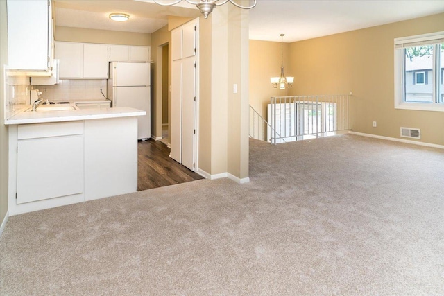 10326 Balsam Ln, Eden Prairie, MN 55347 - kitchen featuring a chandelier, freestanding refrigerator, dark carpet, white cabinetry, and light countertops