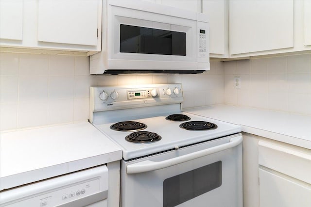 10326 Balsam Ln, Eden Prairie, MN 55347 - kitchen featuring white appliances, white cabinets, light countertops, and tasteful backsplash