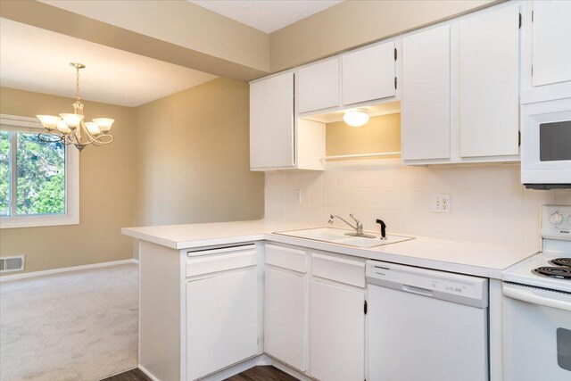 10326 Balsam Ln, Eden Prairie, MN 55347 - kitchen featuring white appliances, a peninsula, a chandelier, white cabinetry, and light countertops