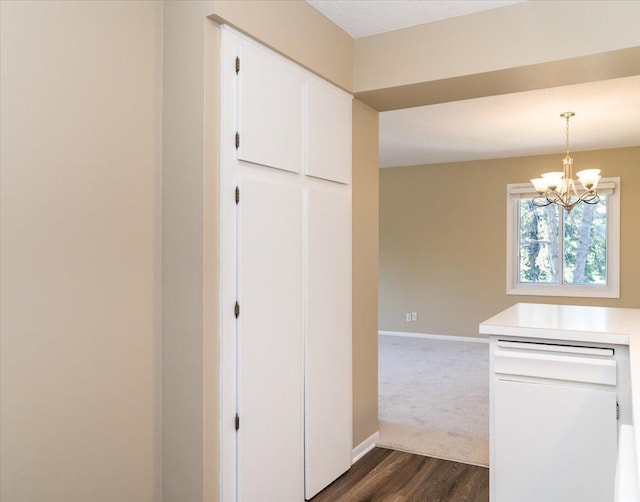 10326 Balsam Ln, Eden Prairie, MN 55347 - kitchen with a chandelier, dark wood-style floors, white cabinetry, light countertops, and pendant lighting