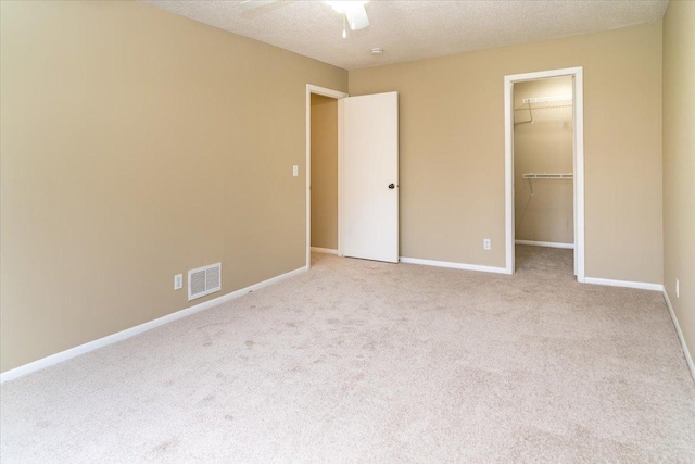 10326 Balsam Ln, Eden Prairie, MN 55347 - unfurnished bedroom featuring carpet, a walk in closet, a closet, and a ceiling fan