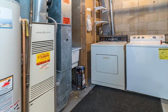 10326 Balsam Ln, Eden Prairie, MN 55347 - laundry area with gas water heater, washer and clothes dryer, heating unit, and concrete block wall