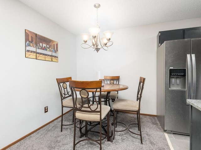 6540 84th Ct N, Brooklyn Park, MN 55445 - dining area featuring a chandelier, baseboards, and light carpet