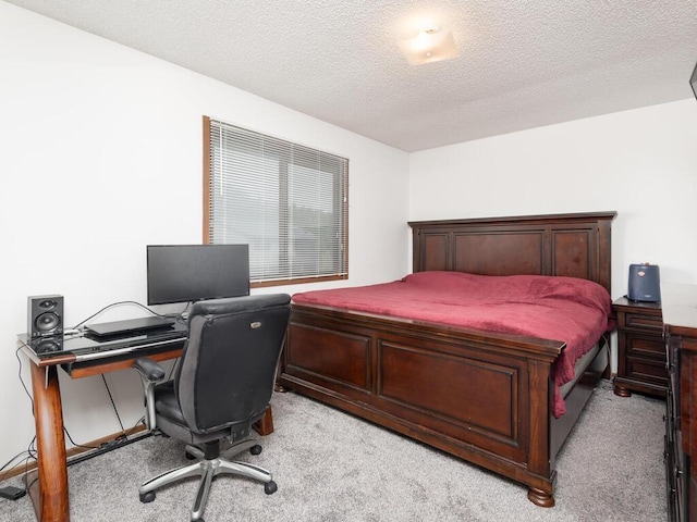 6540 84th Ct N, Brooklyn Park, MN 55445 - bedroom with light colored carpet, a textured ceiling, and a desk