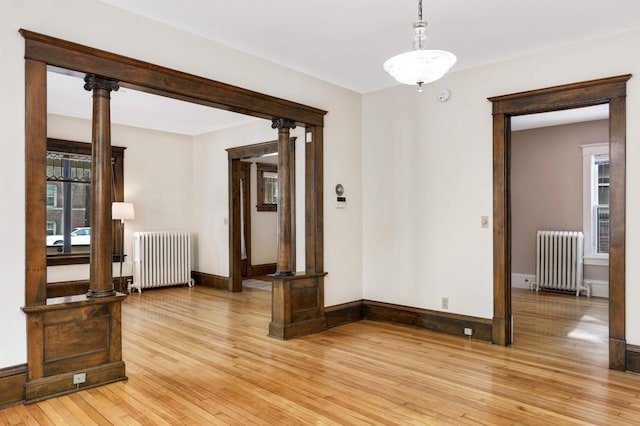2227 Garfield Ave, Minneapolis, MN 55405 - unfurnished room with radiator, light wood-style floors, and baseboards