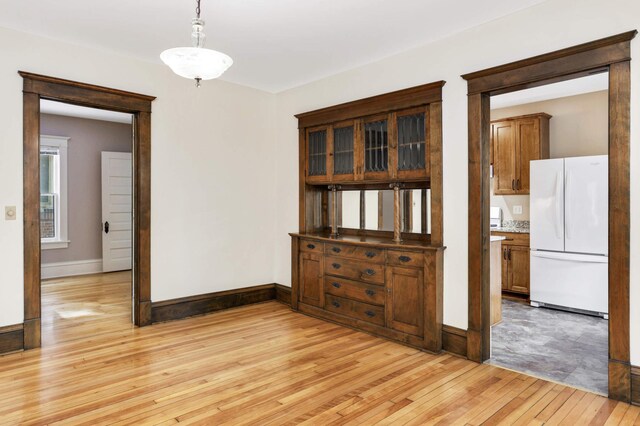 2227 Garfield Ave, Minneapolis, MN 55405 - unfurnished dining area featuring light wood-style flooring and baseboards