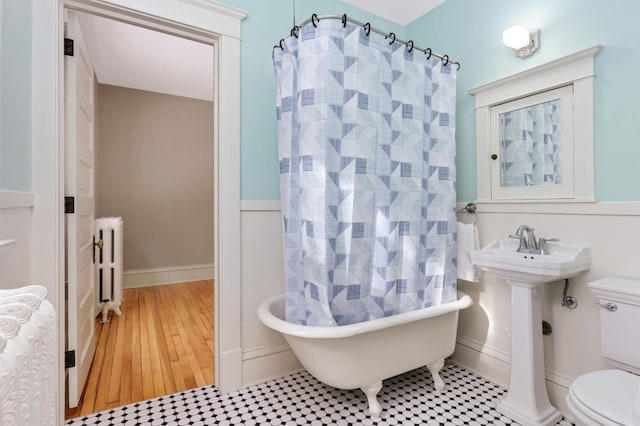 2227 Garfield Ave, Minneapolis, MN 55405 - full bathroom featuring radiator, toilet, a bathtub, and a shower with shower curtain