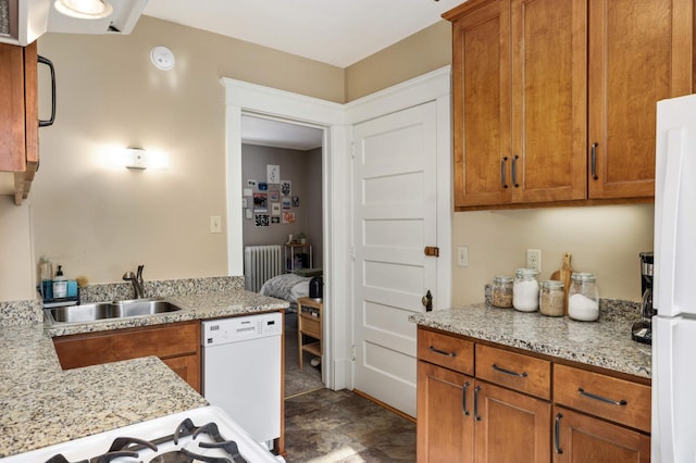 2227 Garfield Ave, Minneapolis, MN 55405 - kitchen with white appliances, a sink, brown cabinets, and radiator