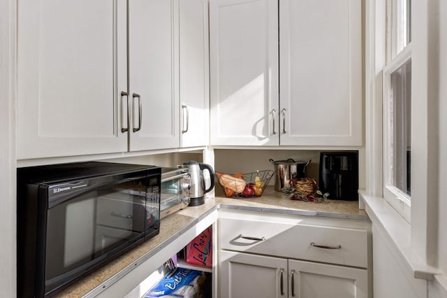 2227 Garfield Ave, Minneapolis, MN 55405 - kitchen with black microwave and white cabinetry