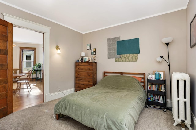 2227 Garfield Ave, Minneapolis, MN 55405 - carpeted bedroom with radiator, crown molding, and baseboards