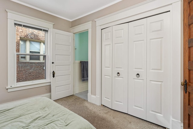 2227 Garfield Ave, Minneapolis, MN 55405 - carpeted bedroom with a closet, ornamental molding, and baseboards