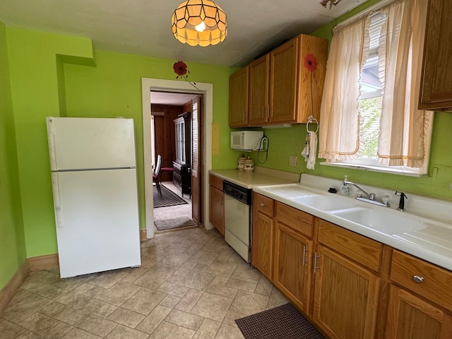 205 Lake Park Blvd, Fairmont, MN 56031 - kitchen with white appliances, light countertops, brown cabinets, and baseboards