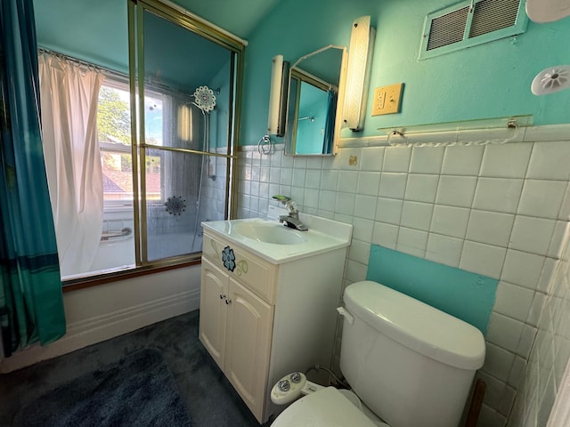 205 Lake Park Blvd, Fairmont, MN 56031 - full bath featuring tile walls, toilet, vanity, shower / bath combination with glass door, and wainscoting