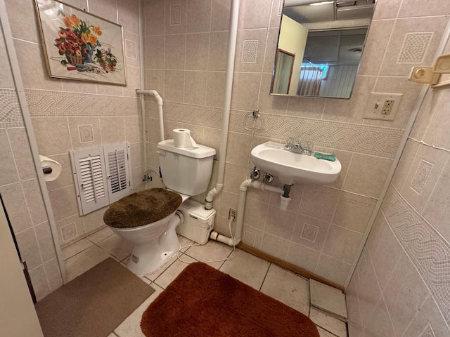 205 Lake Park Blvd, Fairmont, MN 56031 - half bathroom featuring tile walls, toilet, a sink, and tile patterned flooring