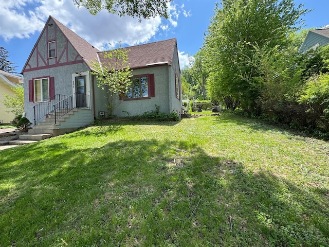 205 Lake Park Blvd, Fairmont, MN 56031 - view of front of home featuring stucco siding, a front yard, and a shingled roof
