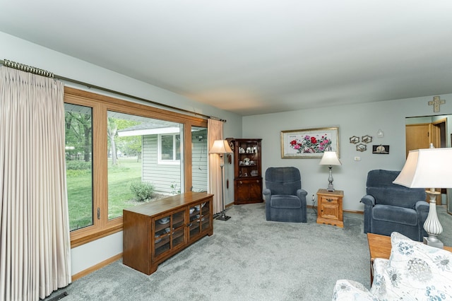 living area with carpet flooring and baseboards
