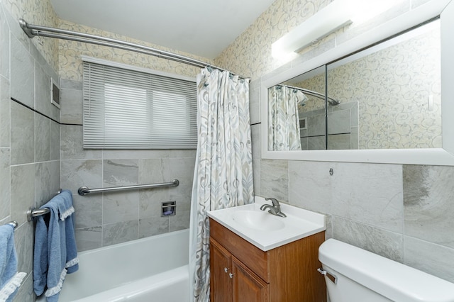 full bathroom with toilet, tile walls, shower / tub combo, and vanity