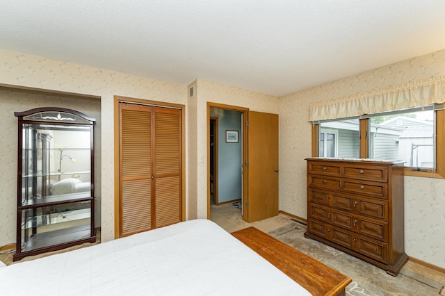bedroom with wallpapered walls, a closet, and light carpet
