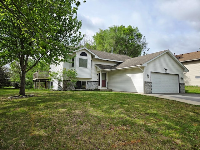 split level home with an attached garage, driveway, a front yard, and roof with shingles