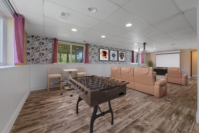 game room with wood finished floors, baseboards, and a paneled ceiling