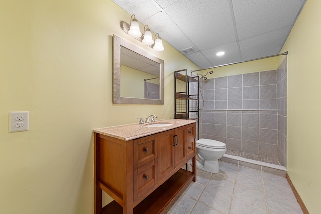 full bath featuring toilet, a tile shower, vanity, recessed lighting, and tile patterned flooring