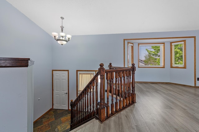 4113 Willowwood St SE, Prior Lake, MN 55372 - stairway with a chandelier, baseboards, high vaulted ceiling, and wood finished floors