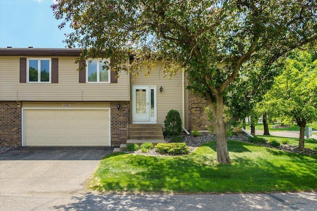 10350 Balsam Ln, Eden Prairie, MN 55347 - view of front of home with brick siding, an attached garage, driveway, and a front lawn