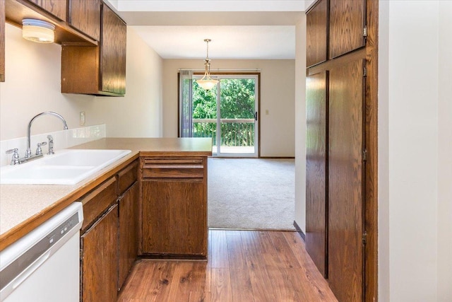 10350 Balsam Ln, Eden Prairie, MN 55347 - kitchen featuring dishwasher, dark wood finished floors, a peninsula, light countertops, and pendant lighting