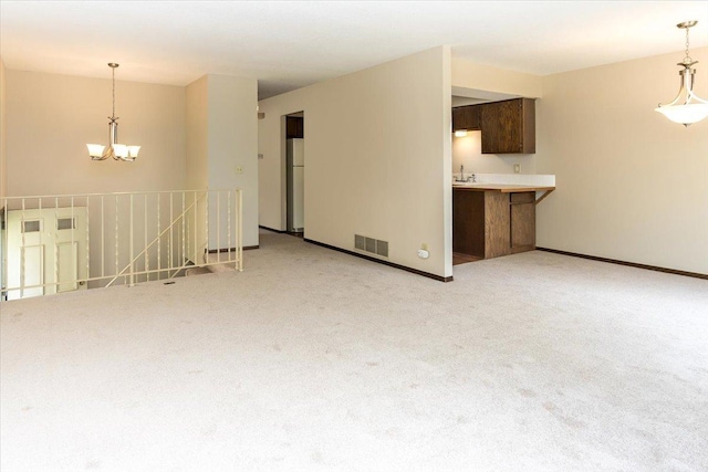 10350 Balsam Ln, Eden Prairie, MN 55347 - unfurnished living room featuring a chandelier and light colored carpet