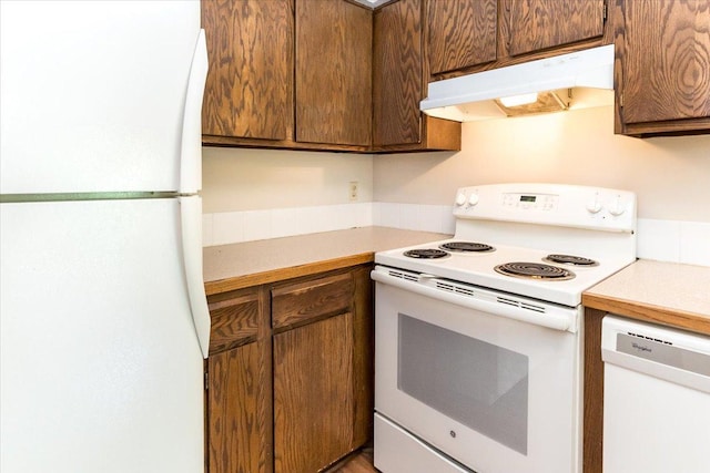 10350 Balsam Ln, Eden Prairie, MN 55347 - kitchen featuring white appliances, under cabinet range hood, and light countertops