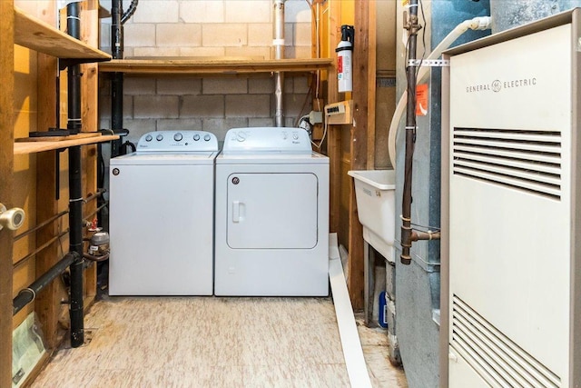 10350 Balsam Ln, Eden Prairie, MN 55347 - laundry area featuring a heating unit, washer and dryer, and concrete block wall