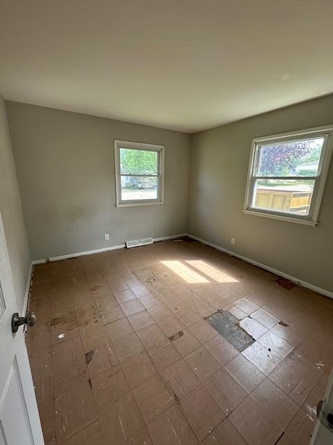 empty room featuring baseboards