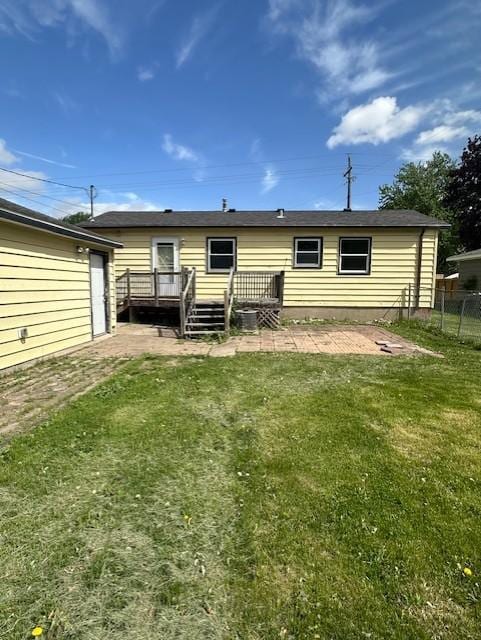 back of house featuring a deck and a patio