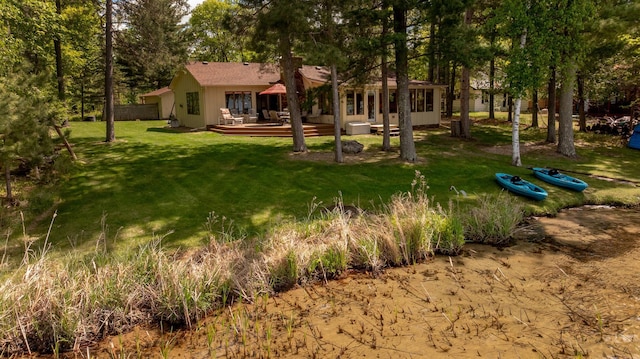 view of green lawn with a wooden deck