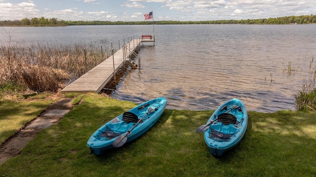 dock featuring a water view and a lawn