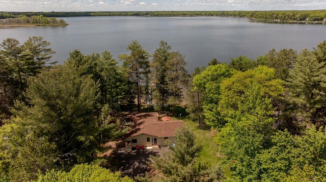 view from above of property featuring a nearby body of water and a forest