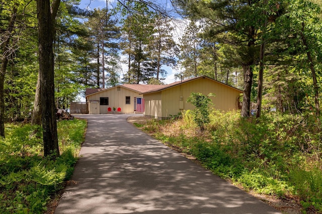 view of front of property featuring asphalt driveway