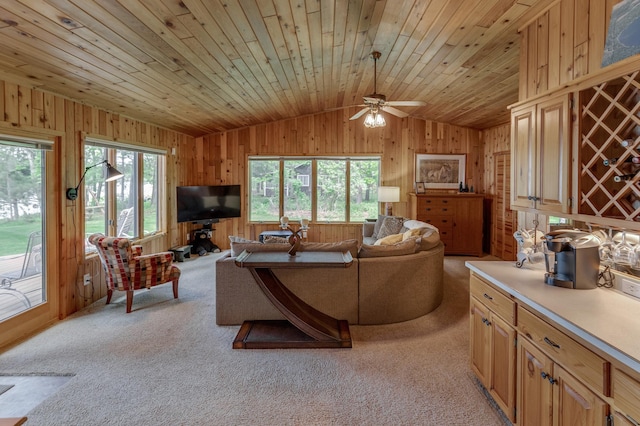 living room featuring lofted ceiling, wooden walls, light colored carpet, ceiling fan, and wood ceiling